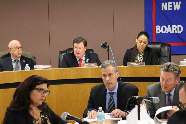 Board of Elections director Michael Ryan, center rear, and BOE commissioners at a post-primary meeting.